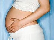 Picture of a pregnant woman holding her belly to represent low birth weight babies and premature birth.