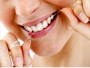 Picture of woman flossing her teeth