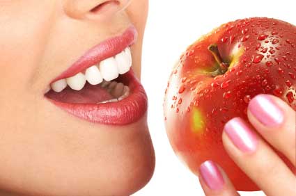 Pic of woman eating an apple to promote cosmetic dentistry.