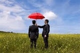 Picture of men holding an umbrella