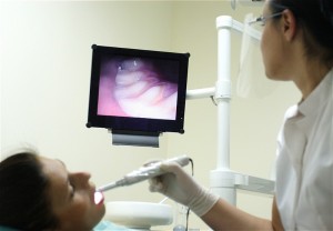 Picture of a patient viewing a real-time image of their tooth.