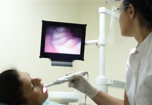 intraoral_camera Picture of a patient viewing a real-time image of their tooth.